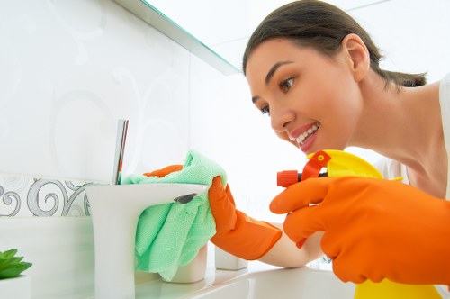 A cleaner working in a Richmond kitchen and living area
